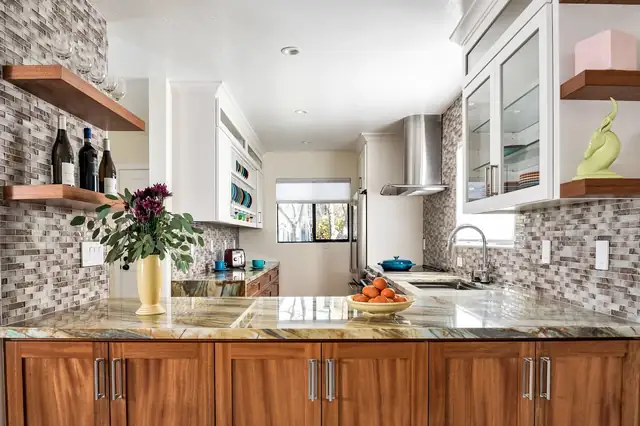 Coastal condo remodel in Santa Cruz with white cabinetry, a wood-front island and open shelving