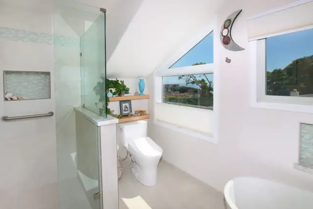 Pleasure Point bathroom with a frameless glass shower, glass tile niche and ocean-view windows