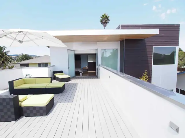 Westside Santa Cruz contemporary home roof deck with white decking, outdoor seating and palm views